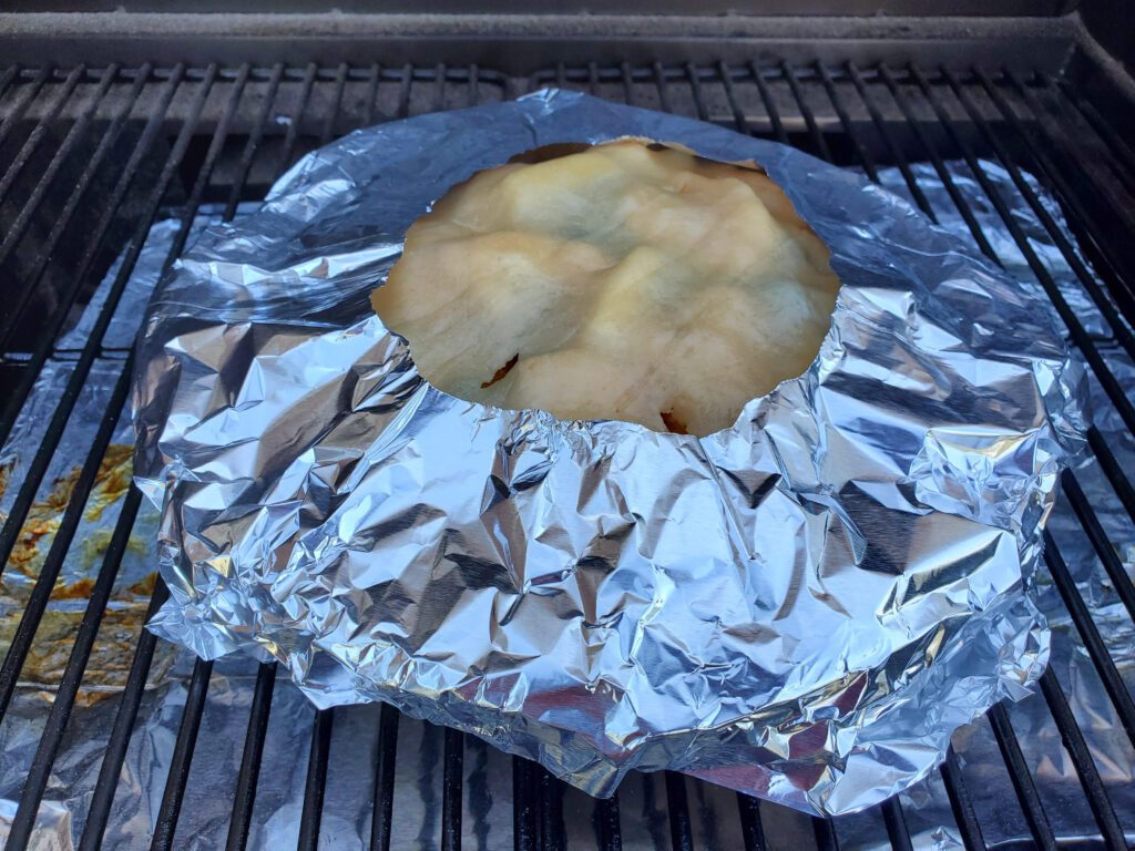 Peach Blueberry pie with foil covering edges