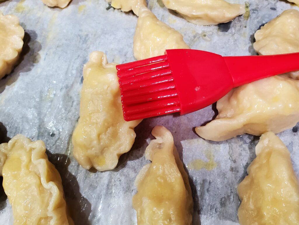 Coat boiled pierogi with melted butter to prevent sticking.