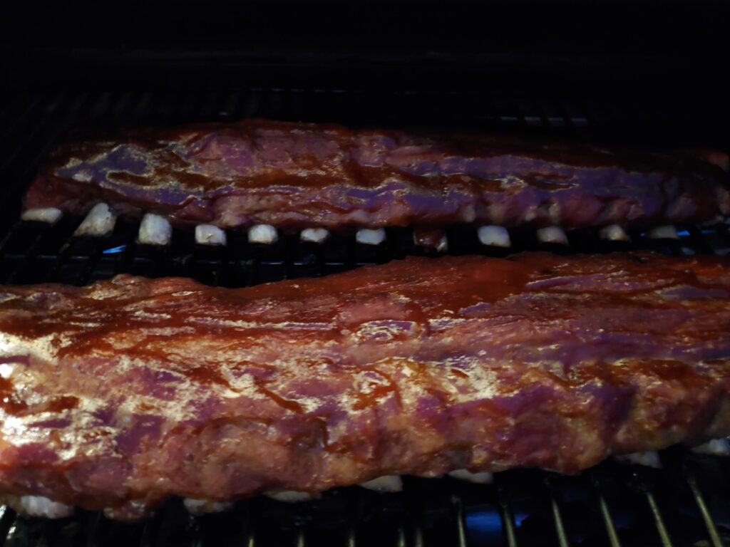 baby back ribs with sauce on the Traeger