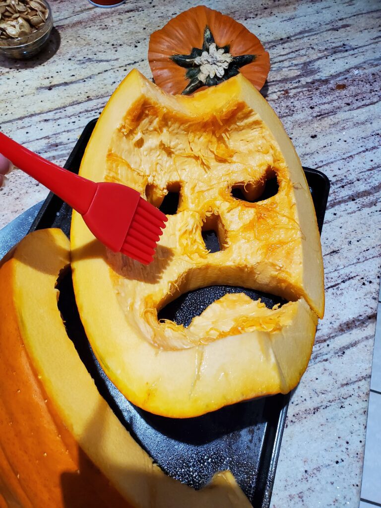 Spreading oil on a pumpkin