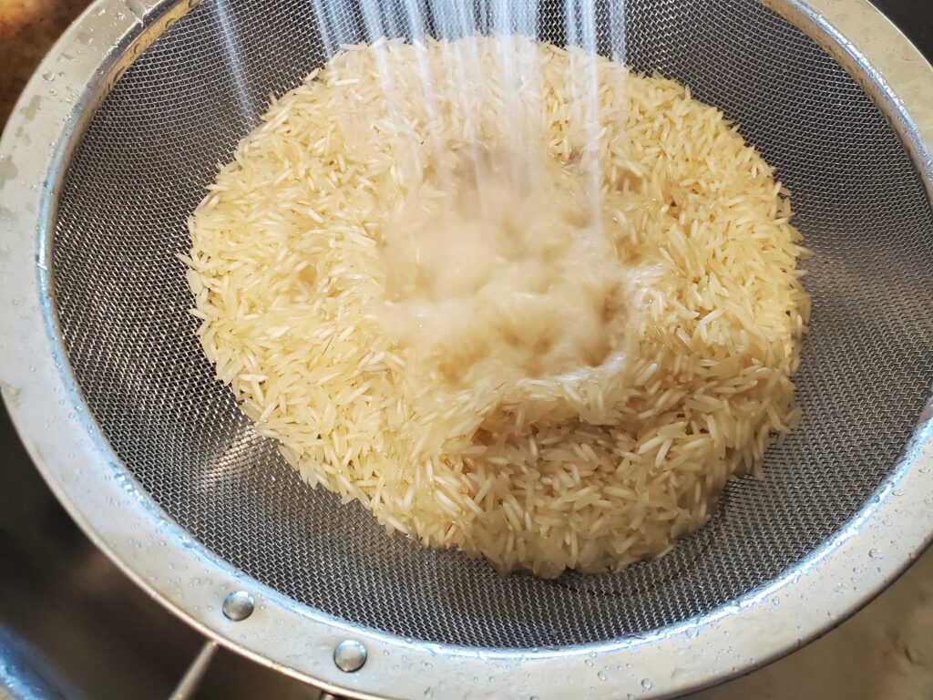 Rinsing rice through a fine mesh strainer