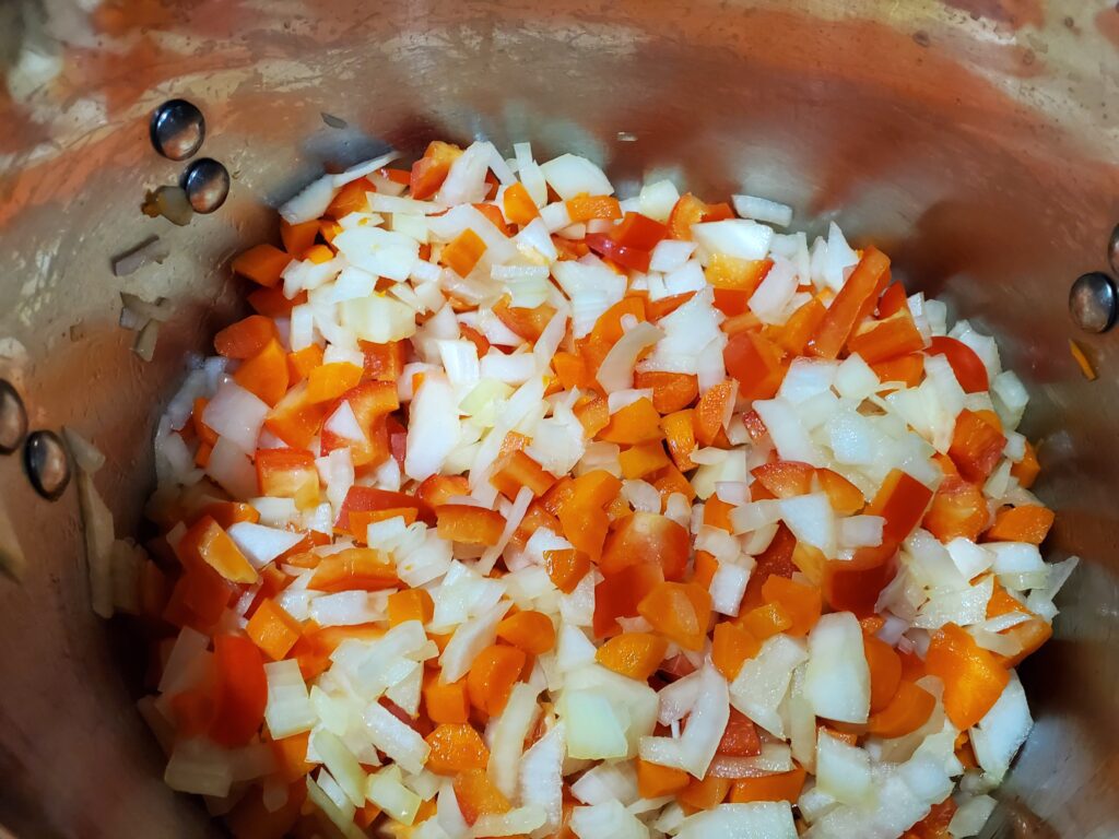Peppers onions and carrots in a pan