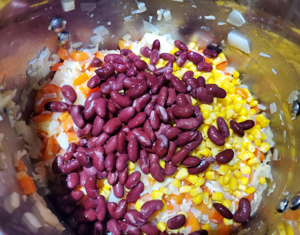Add kidney beans, corn, and 1/2 cup of coconut milk.