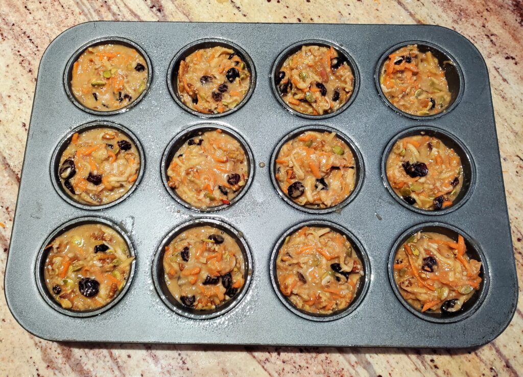 Filling muffin cups with morning glory batter