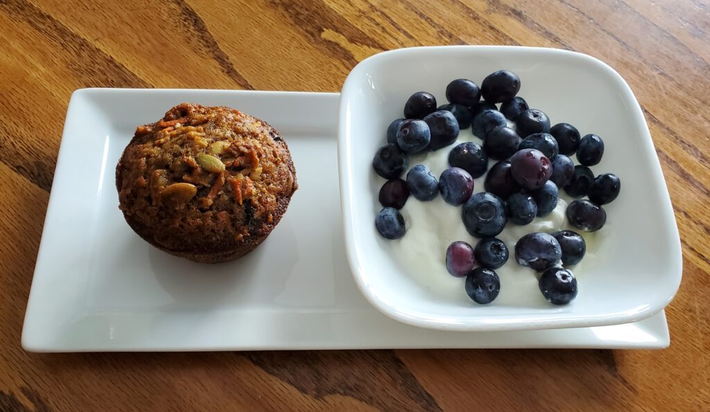 Morning glory muffin served with yogurt and fruit