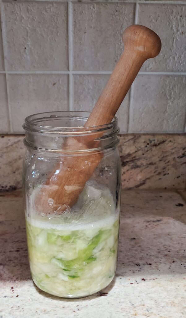 press cabbage down into jar