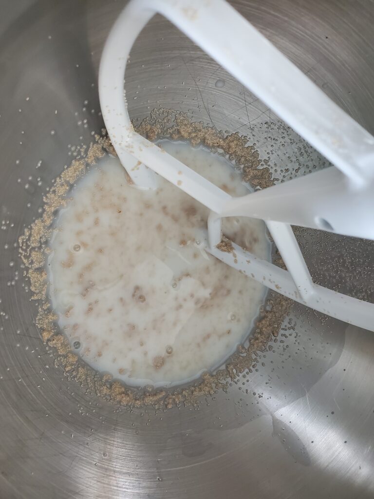 milk, yeast and sugar in a stand mixer