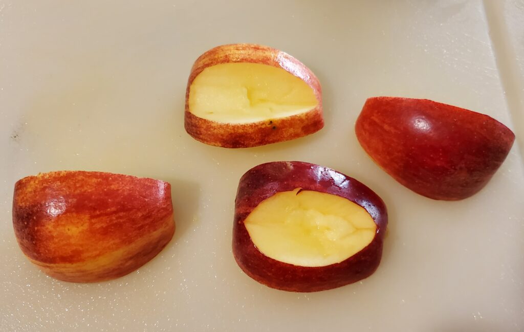 Quartered apple with cut out for mouth