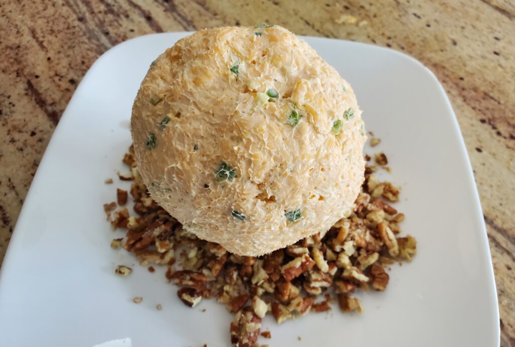 Roll the cheese ball into the pecans