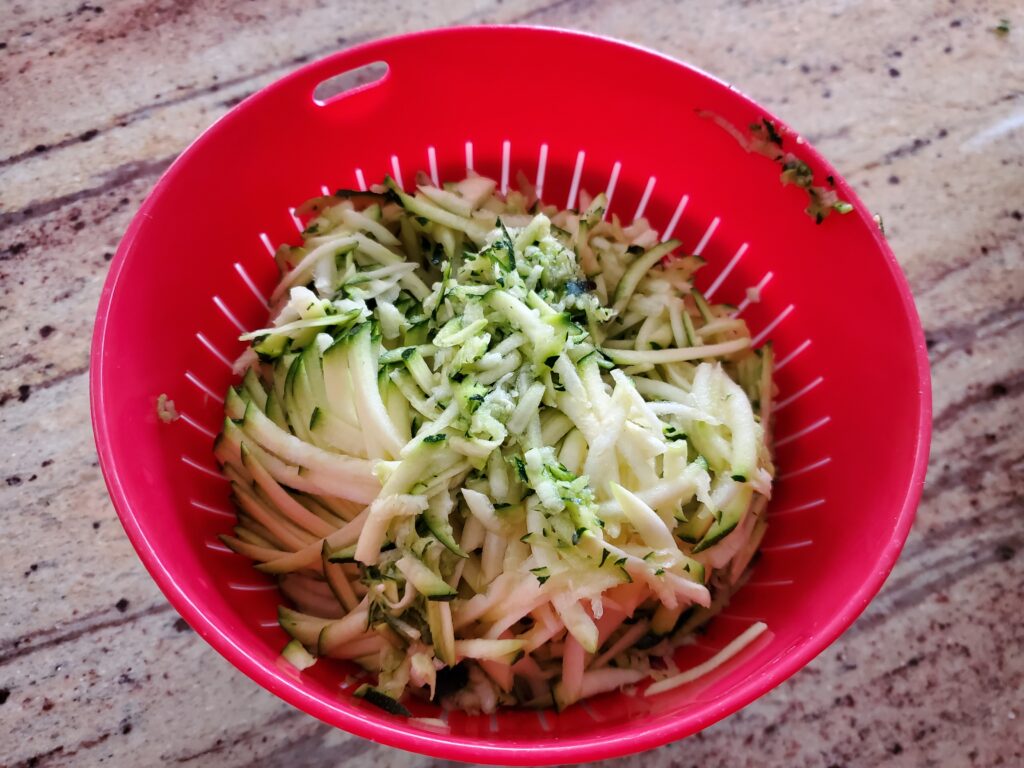 grated zucchini in a colander